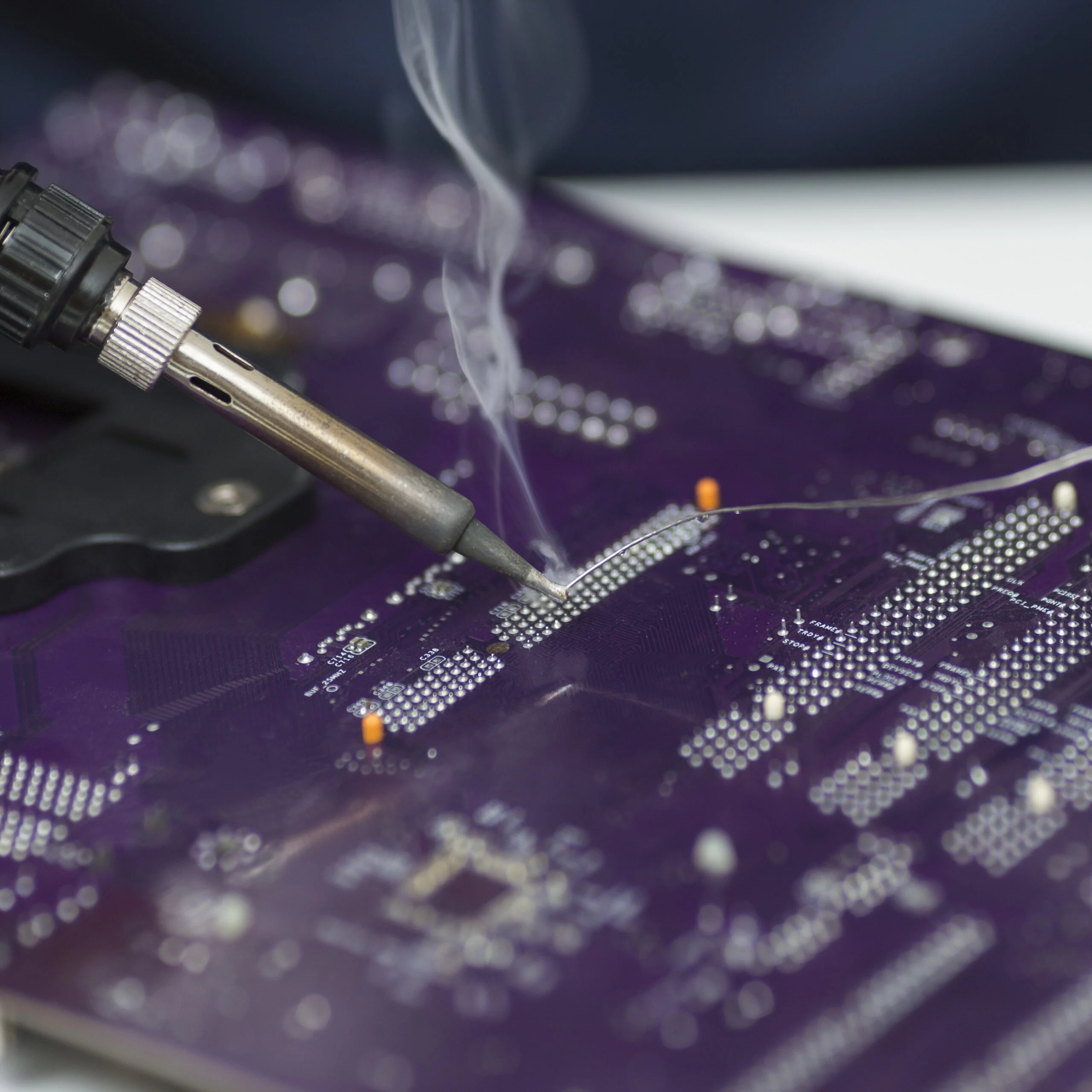 close-up-reparation-computer-motherboard Technician soldering a printed circuit board
