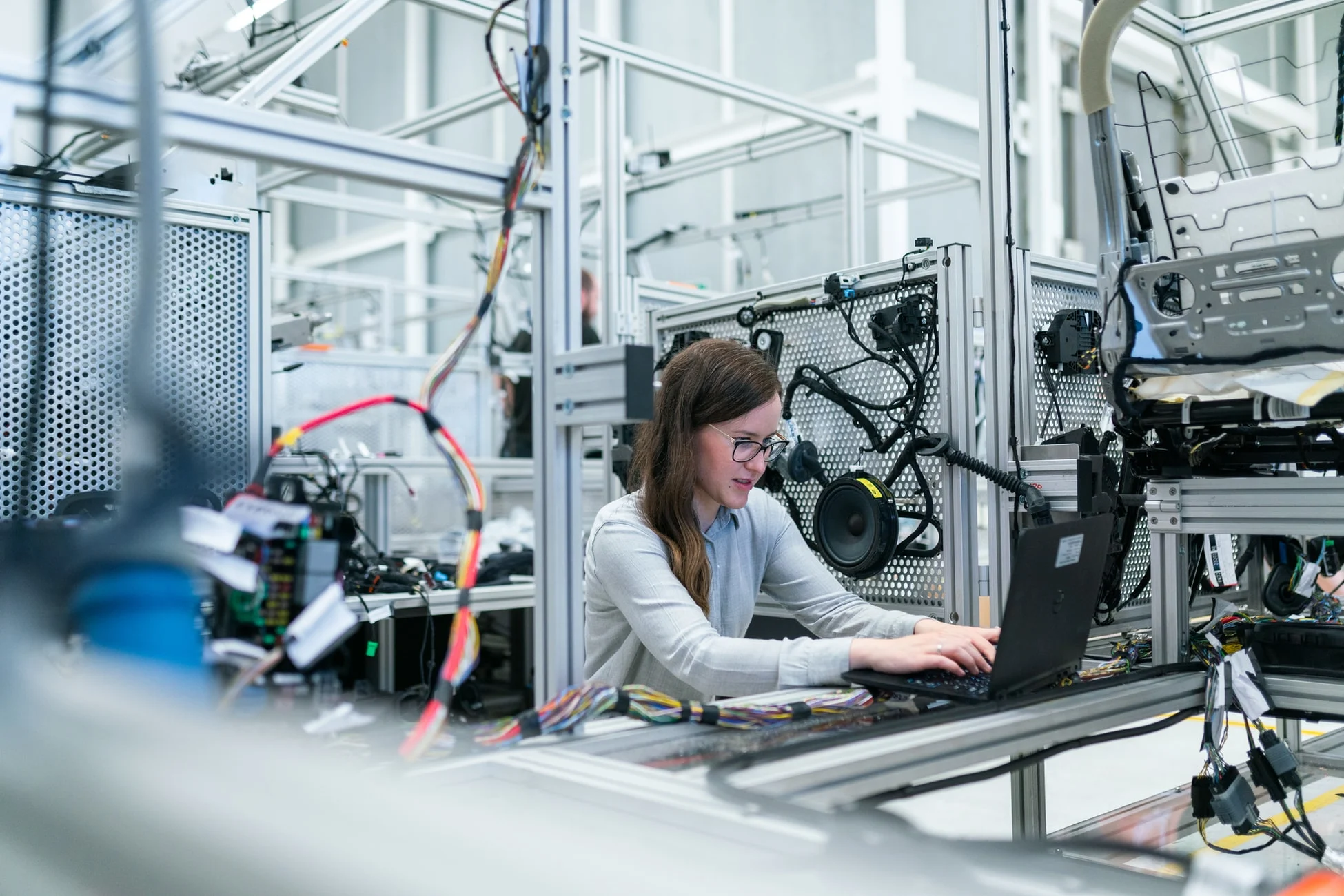 Technician working on industrial equipment in a manufacturing plant