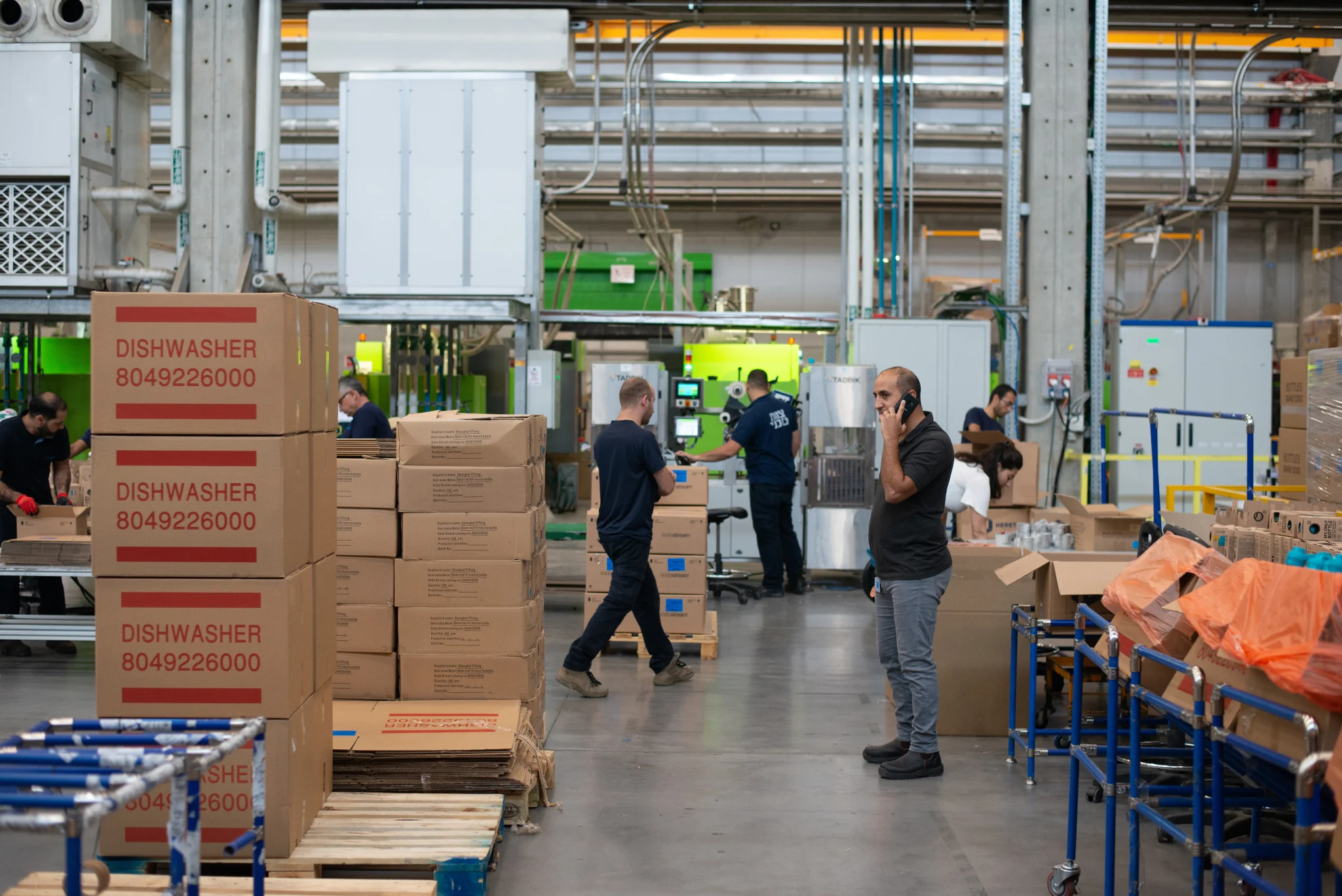 Workers reviewing operations on a manufacturing floor