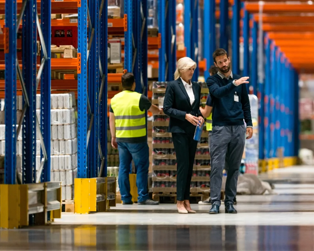 A pair of lean consultants auditing the floor of a smart warehousing facility